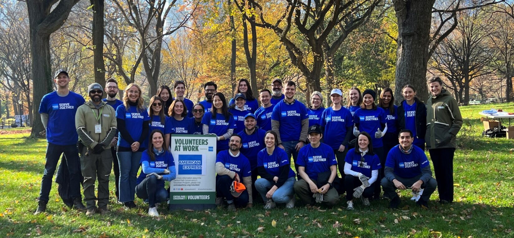 A group of volunteers pose for a photograph in the park